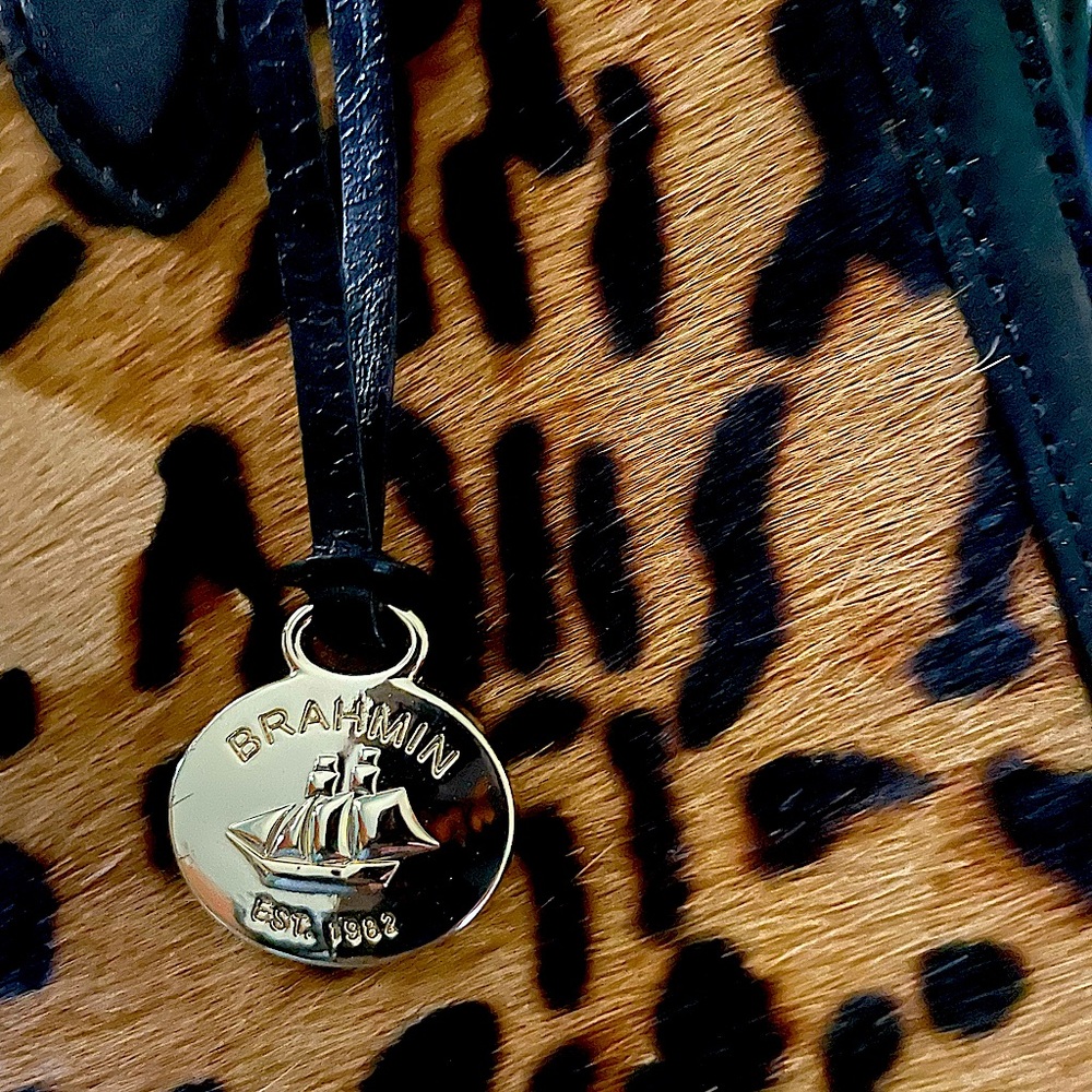 Black leather with leopard print front has authenticity card
